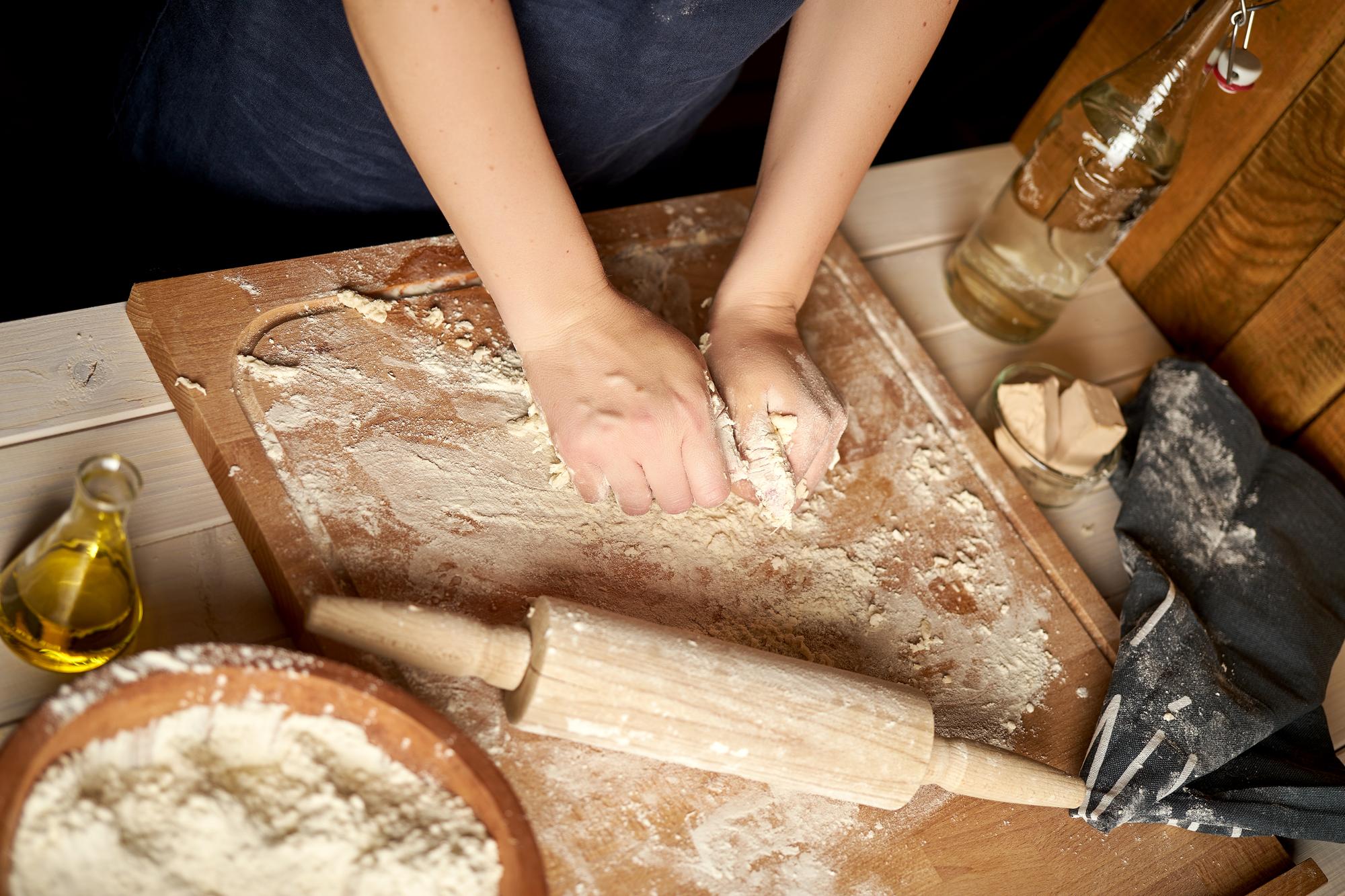 close-up of hands kneading dough