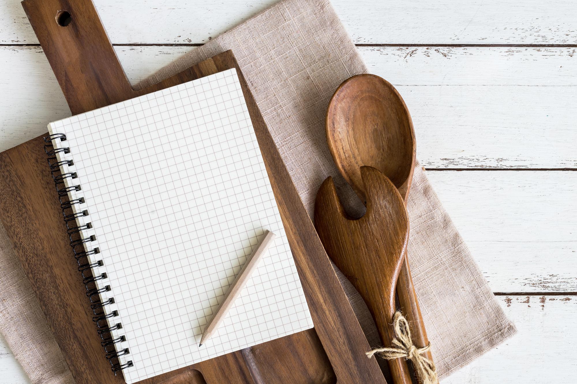 stacked recipe notebooks and tools